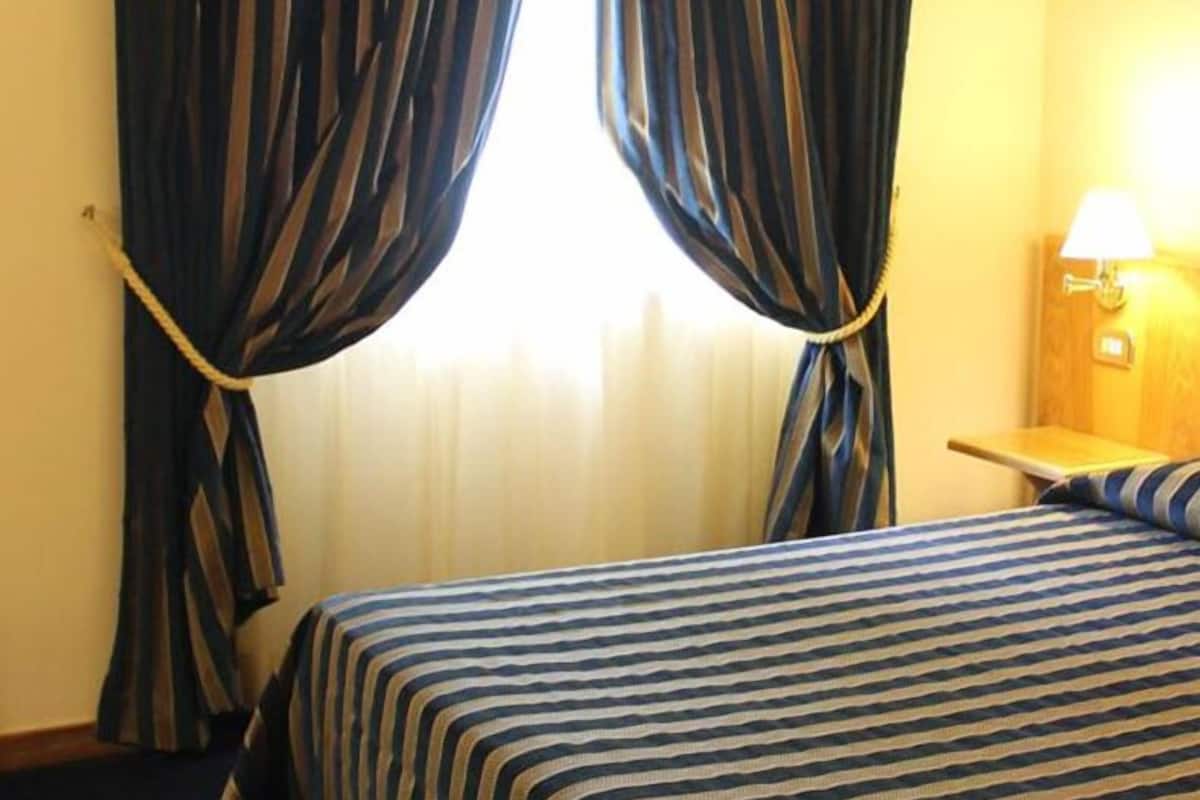 Standard Double Room | Minibar, desk, blackout drapes, iron/ironing board