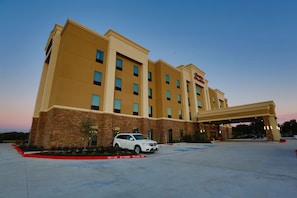 Hotel features a flat roof and symmetrical facade with a brick and panel design.