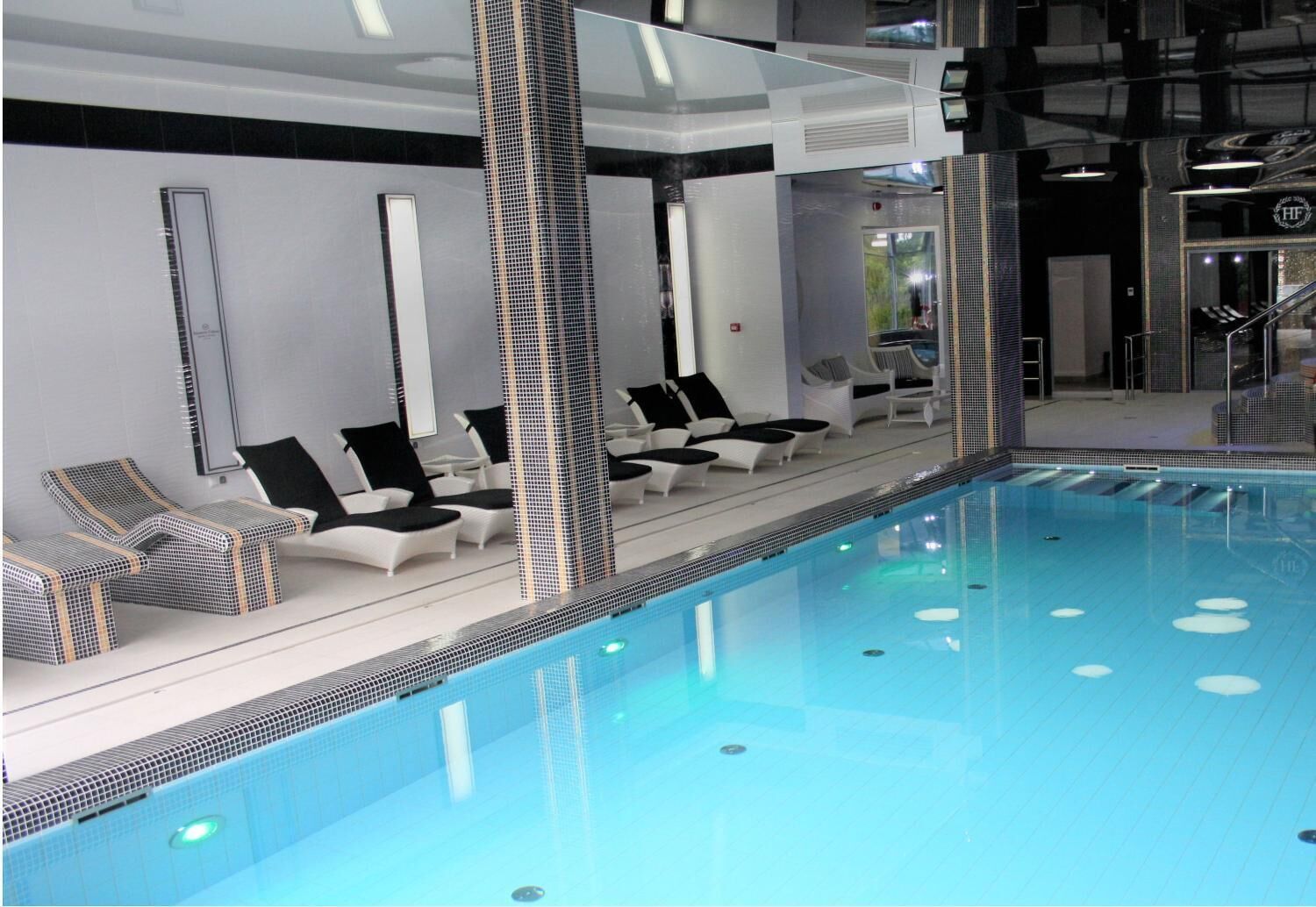 indoor pool, pool loungers, lifeguards on site