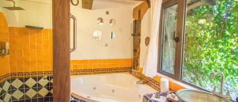 A bathroom with a bathtub, a sink, and a shower.