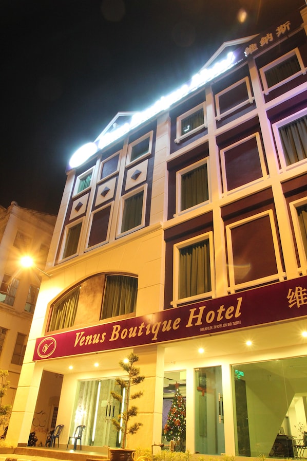 A hotel with a sign reading "Venus Boutique Hotel."