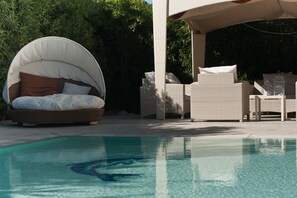 Seasonal outdoor pool, a waterfall pool, pool umbrellas, pool loungers