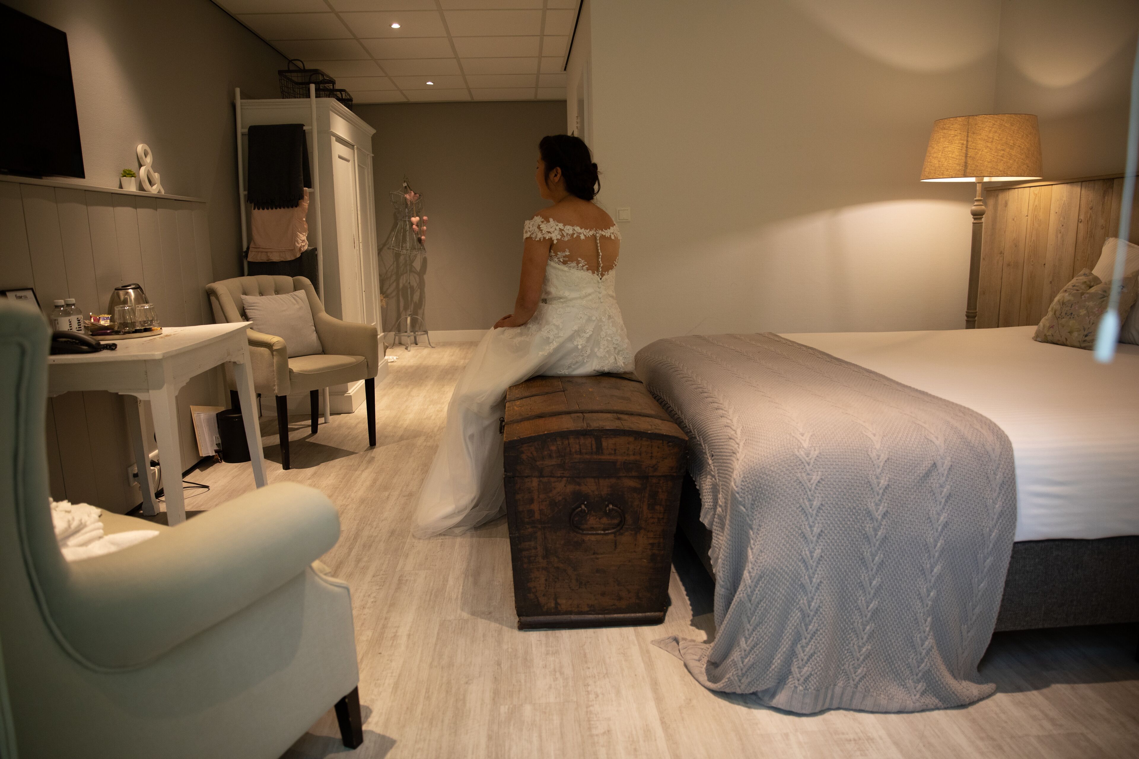 A bedroom with a bed, a chest of drawers, a desk, and a chair.