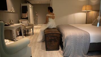 A bedroom with a bed, a chest of drawers, a desk, and a chair.