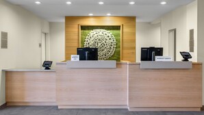 A hotel reception area with two reception desks labeled "Marriott Bonvoy Elite" and "Marriott Bonvoy." - Fairfield Inn & Suites by Marriott Fort Walton Beach Hurlburt Area (Fort Walton Beach)