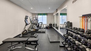 A gym with treadmills, an elliptical, a bench, and dumbbells. - Fairfield Inn & Suites by Marriott Fort Walton Beach Hurlburt Area (Fort Walton Beach)