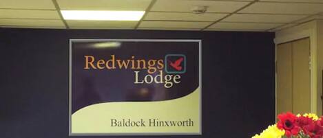 A Redwings Lodge sign with a logo and location name.