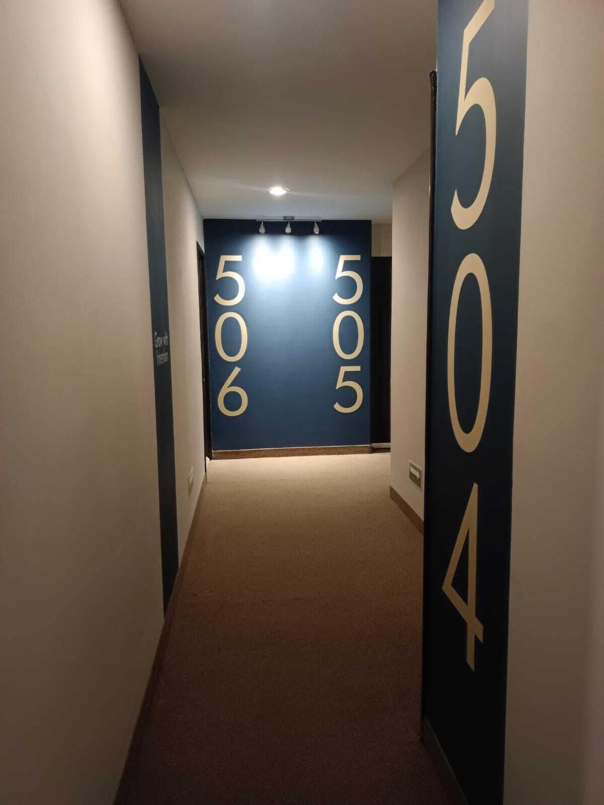 A hallway with a carpeted floor and walls featuring large numbers.