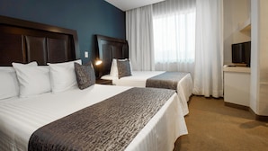 A hotel room with two beds, a TV, and a large window with curtains. - Best Western Real Tula Express (Tula de Allende)