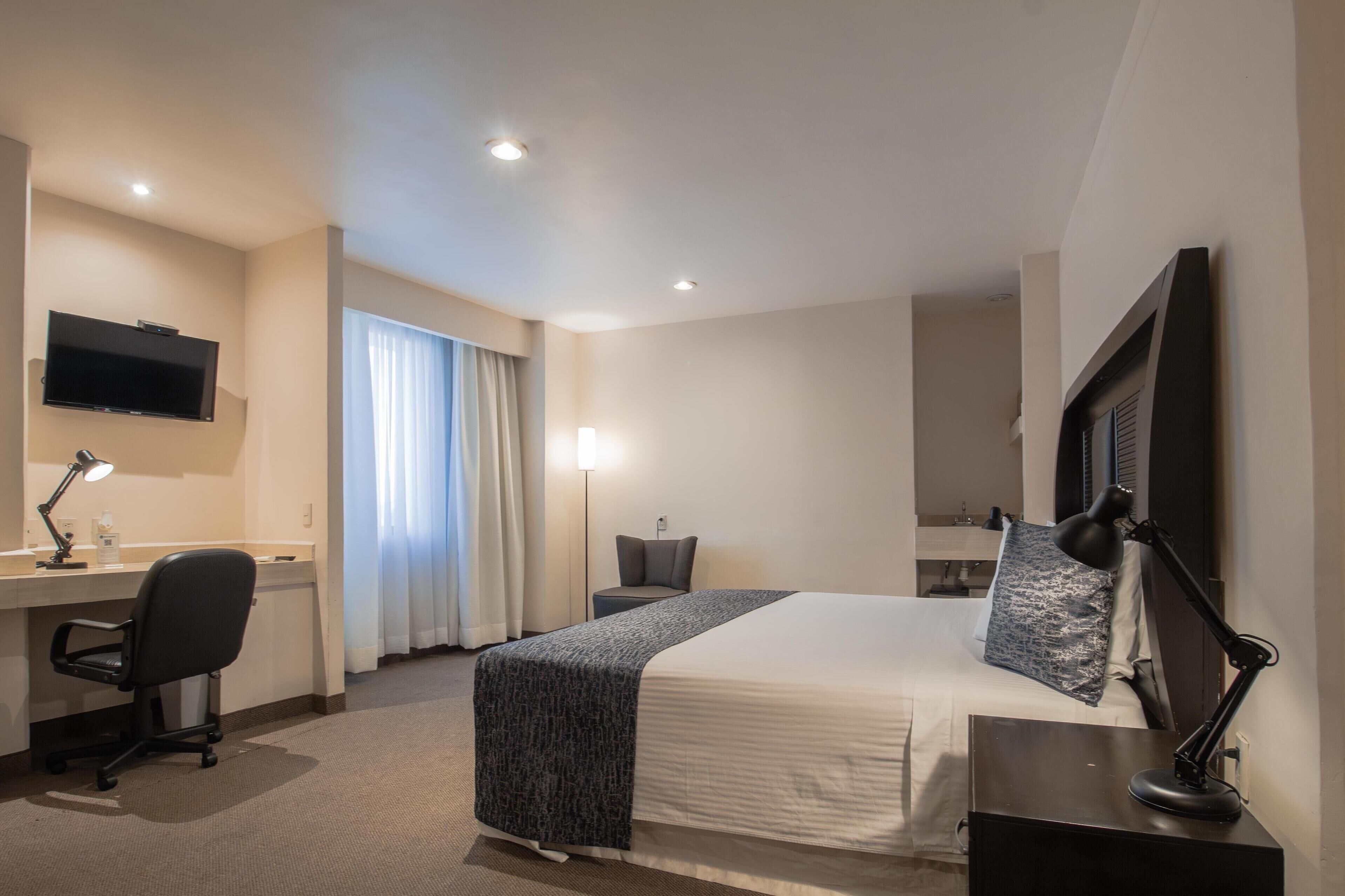 suite, 1 king bed, non smoking | minibar, desk, iron/ironing board, bed sheets