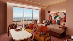 A modern hotel room with a large balcony, a sofa, a table, and a bed. - THE NEST ISHIGAKI (Ishigaki)
