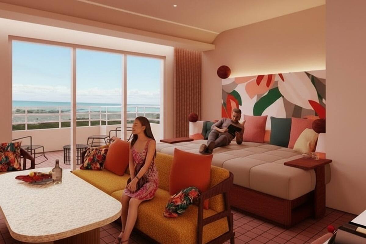 A modern hotel room with a large balcony, a sofa, a table, and a bed.