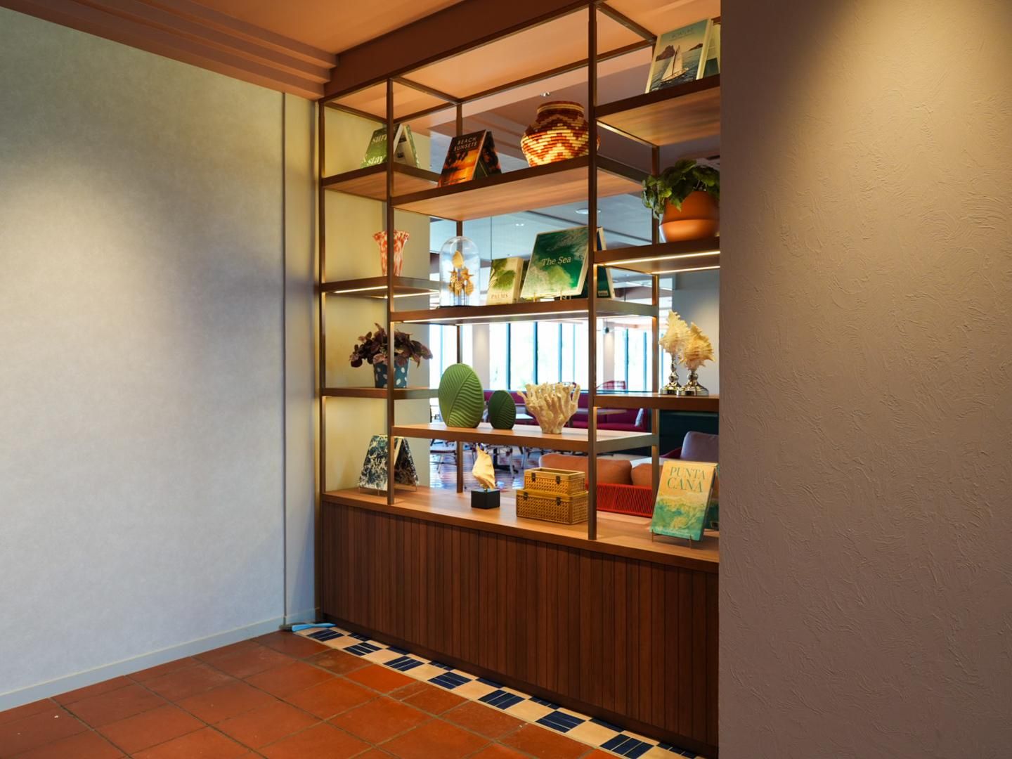 A hallway with a tiled floor and a wooden bench.