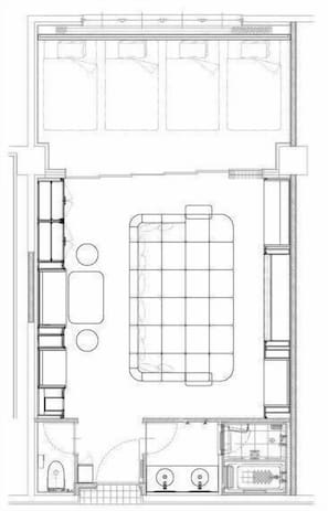 Plano de un cuarto de hotel que muestra una cama, un escritorio, una silla, una mesita y un baño.