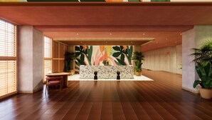 A reception area with a tiled floor, a reception desk, and large windows with blinds. - THE NEST ISHIGAKI (Ishigaki)