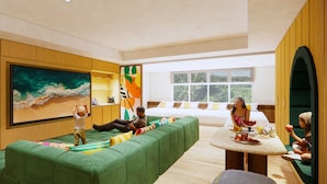A modern living room with a green sofa, a large painting, and a view of greenery outside. - THE NEST ISHIGAKI (Ishigaki)