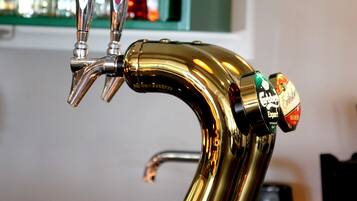 A gold-colored tap with two spouts and a label indicating 'Golden Export' beer.