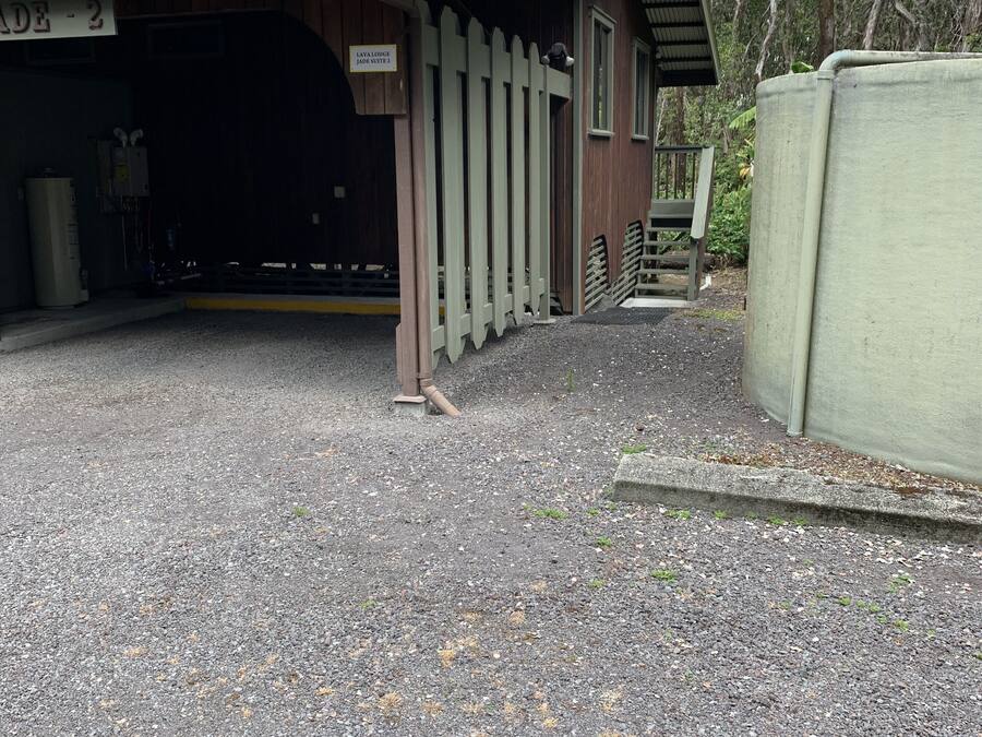 A rustic building with a wooden exterior and a metal roof, labeled "Lava Lodge Lava Suite 2".