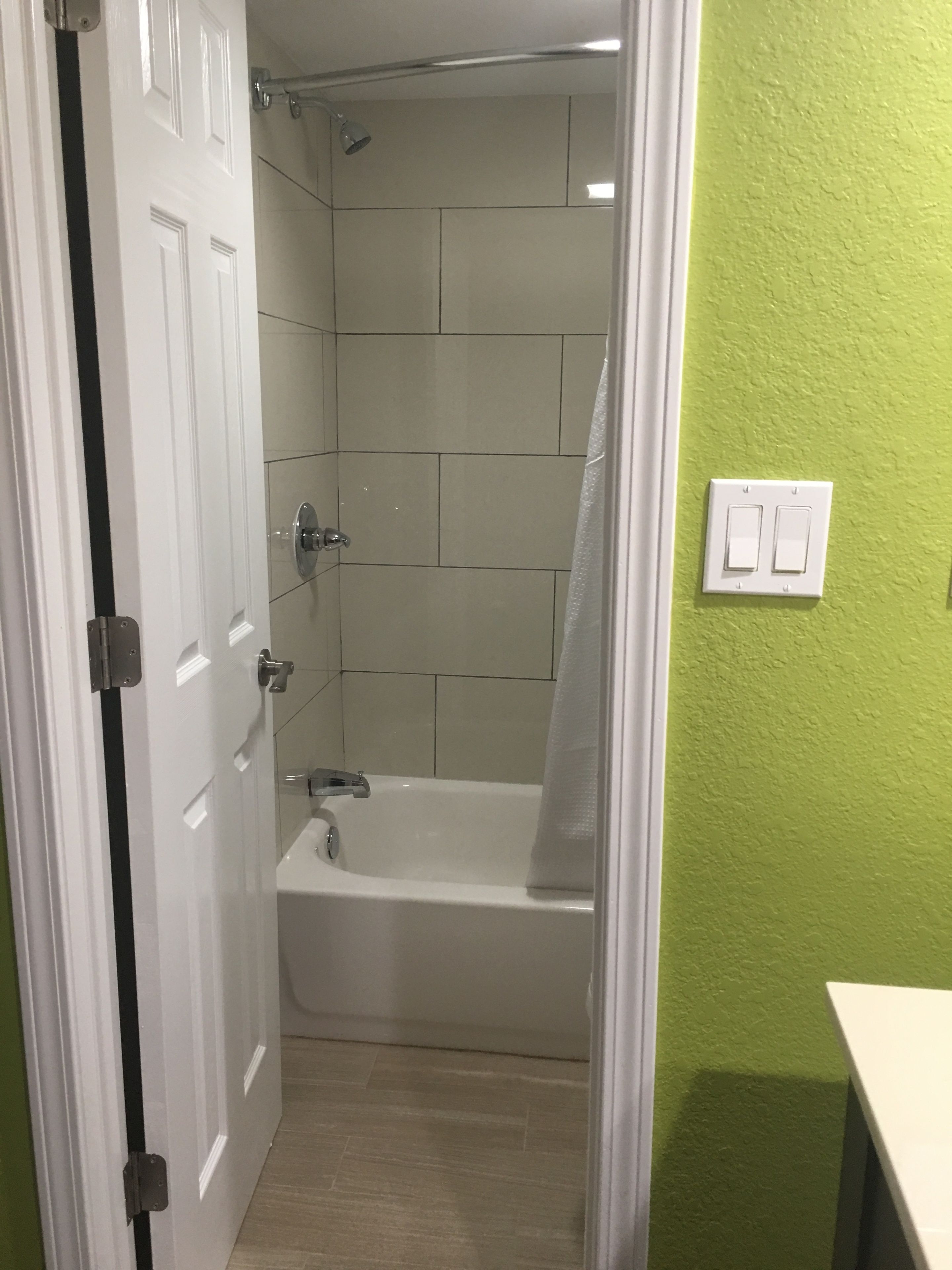 A bathroom with a shower, a bathtub, and a toilet.