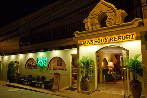 The exterior of Baan Souy Resort with a prominent entrance, seating area, and a neon sign. - Baan Souy Resort (Pattaya)