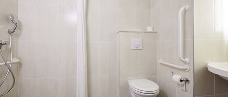 A bathroom with a shower, toilet, and grab bars.