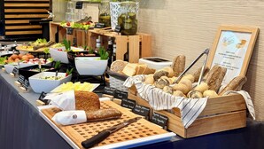 A buffet with various food items including bread, salads, and condiments. - Boutique Hotel’s I Milionowa (Lodz)