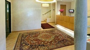 A hotel lobby with a patterned carpet, a reception desk, and a staircase. - Hotel Ristorante Vecchia Riva (Varese)
