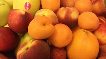 A variety of fruits including apples, oranges, and peaches.