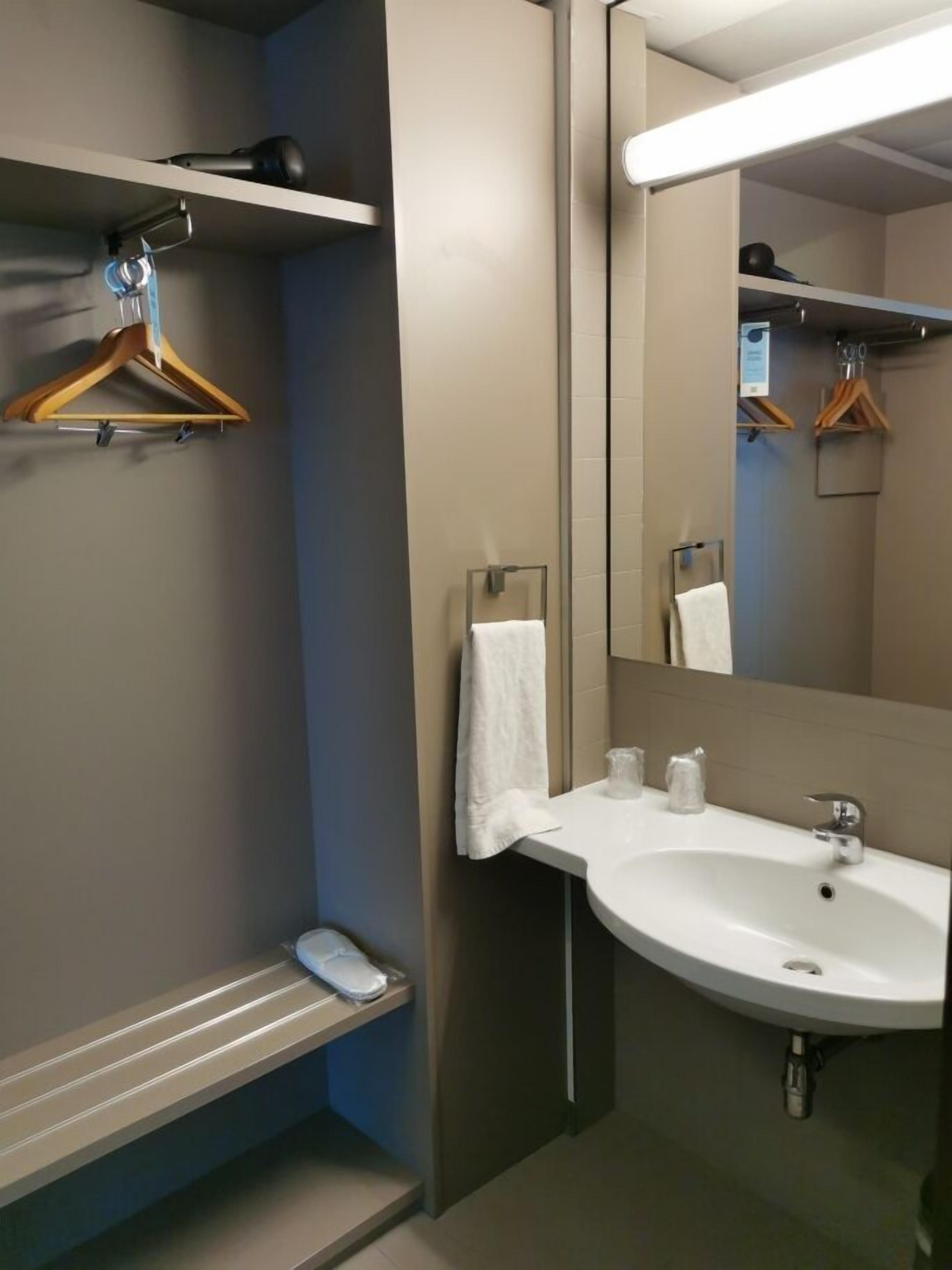 junior suite, 1 king bed | bathroom | eco-friendly toiletries, hair dryer, towels