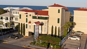 A hotel with a red roof, a flag, and a view of the sea. - DeSoto Beach Hotel (Tybee Island)