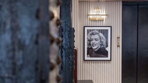 A reception area with a framed portrait, a reception desk, and a wall-mounted light.