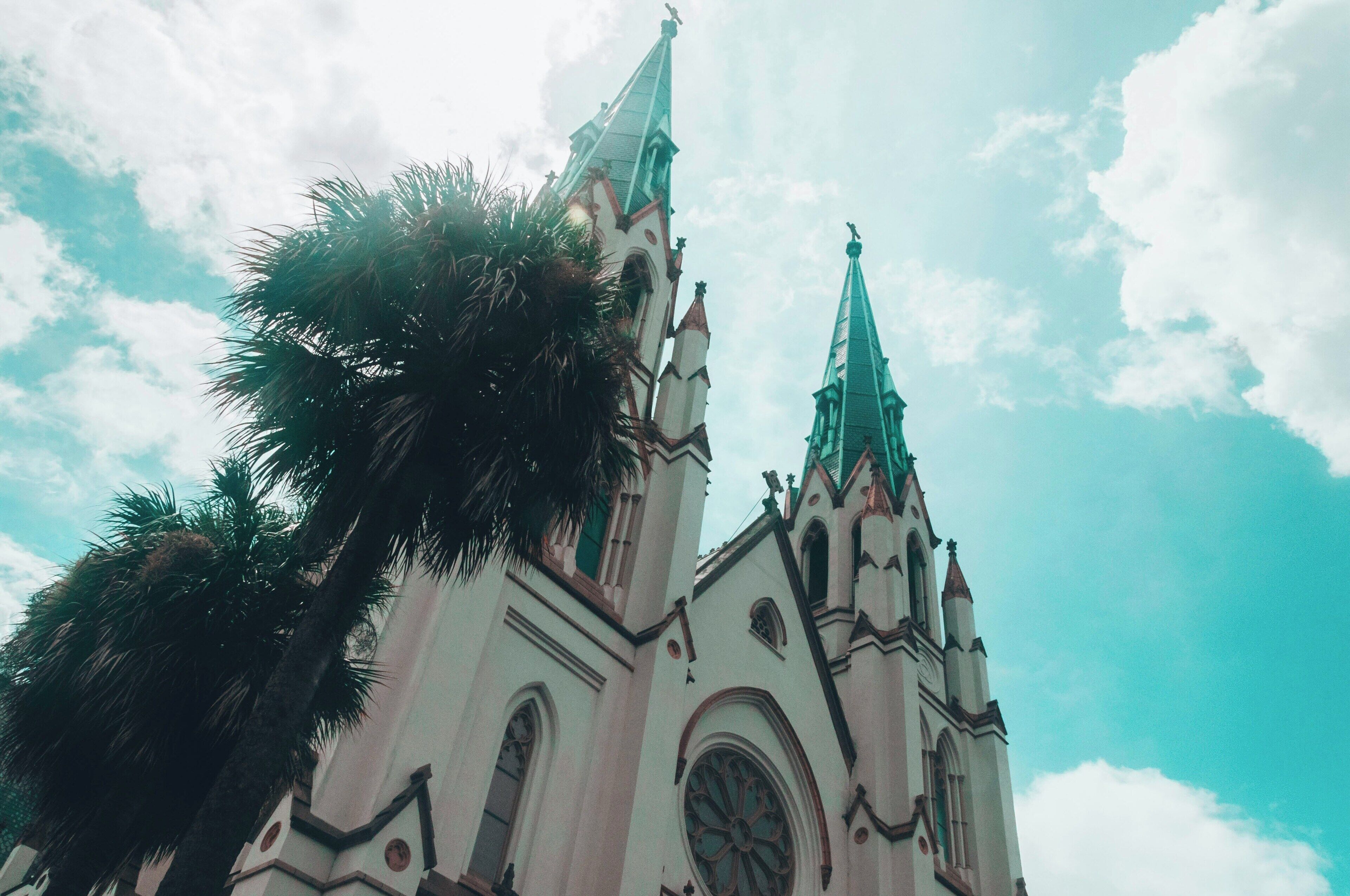 A church with two tall spires and a large arched window.