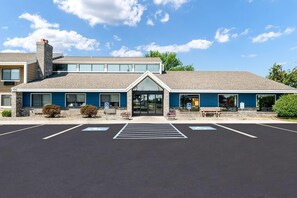 A two-story building with a parking lot in front. - AmericInn by Wyndham Bemidji (Bemidji)