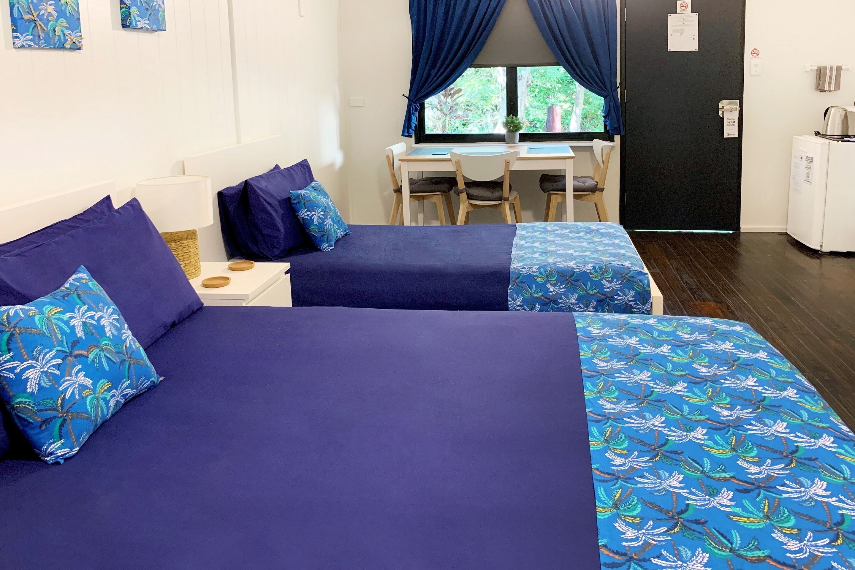 Een kamer met twee bedden, een bureau en een stoel.