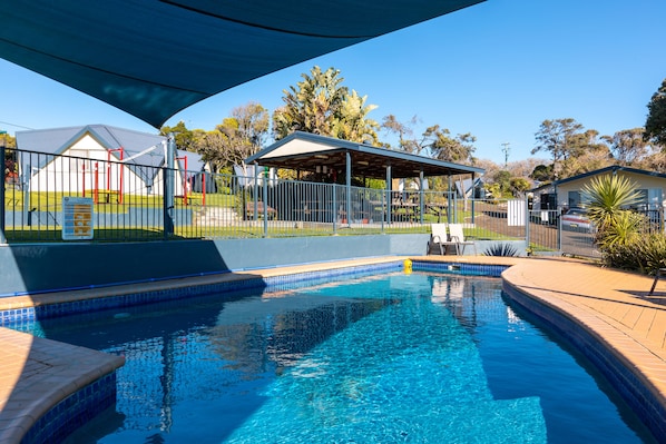 Outdoor pool, a heated pool, pool umbrellas