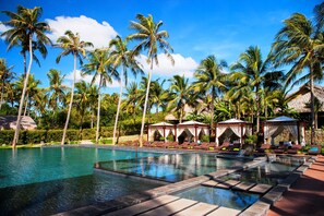 Relax by the resort's large rectangular pool surrounded by lounge chairs and shaded cabanas.