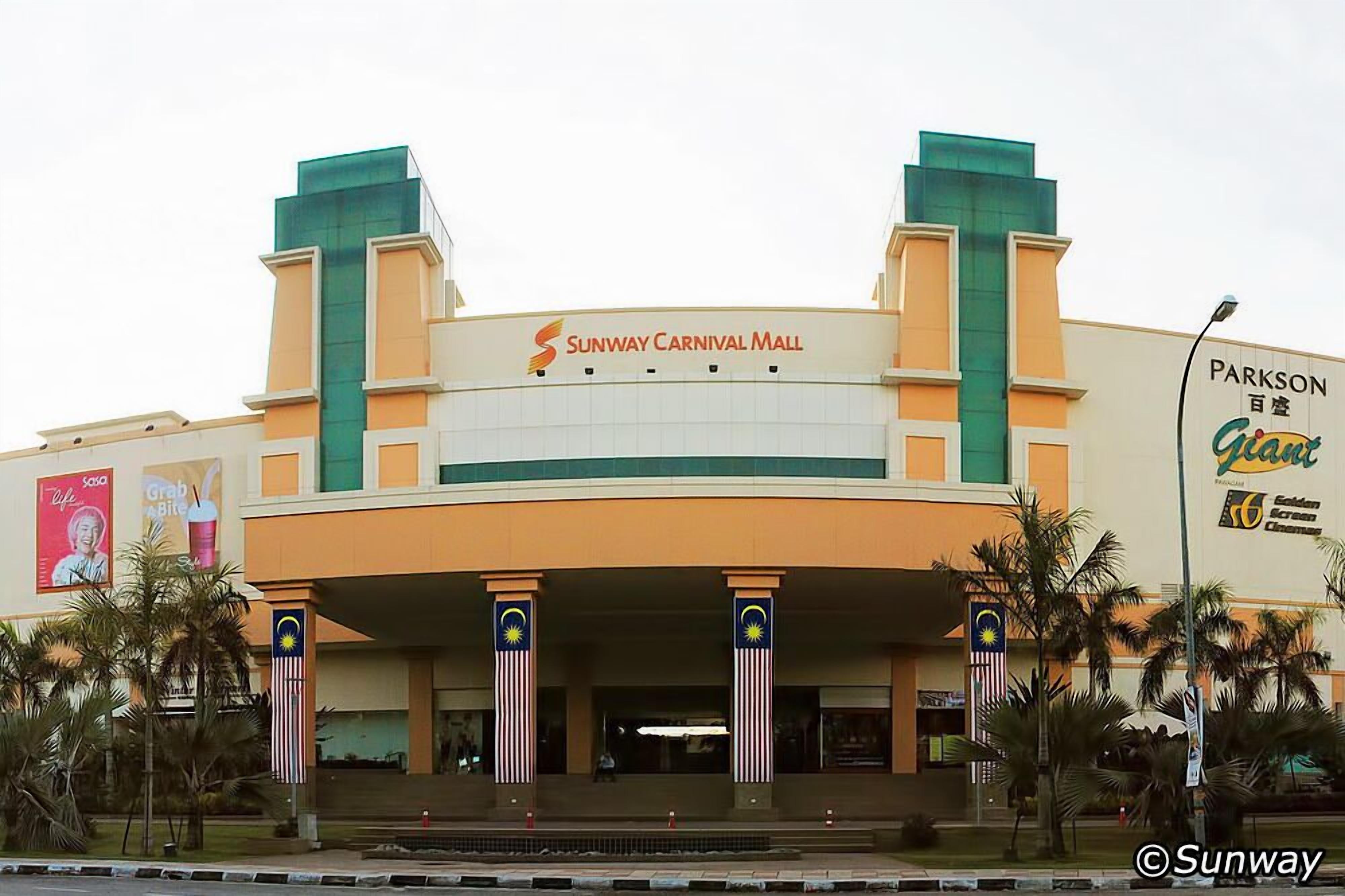 A building with a sign that reads "Sunway Carnival Mall" and another sign for "Parkson."