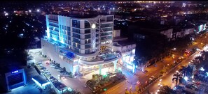 Stunning multi-story building with a curved facade and balconies, offering a unique urban experience.