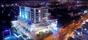 A multi-story hotel with a modern design, featuring a prominent entrance and a parking area. - Galaxy Hotel Banjarmasin (Banjarmasin)