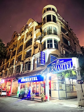 A building with a prominent sign for "Burma Hotel" and "Wisma Aisama."