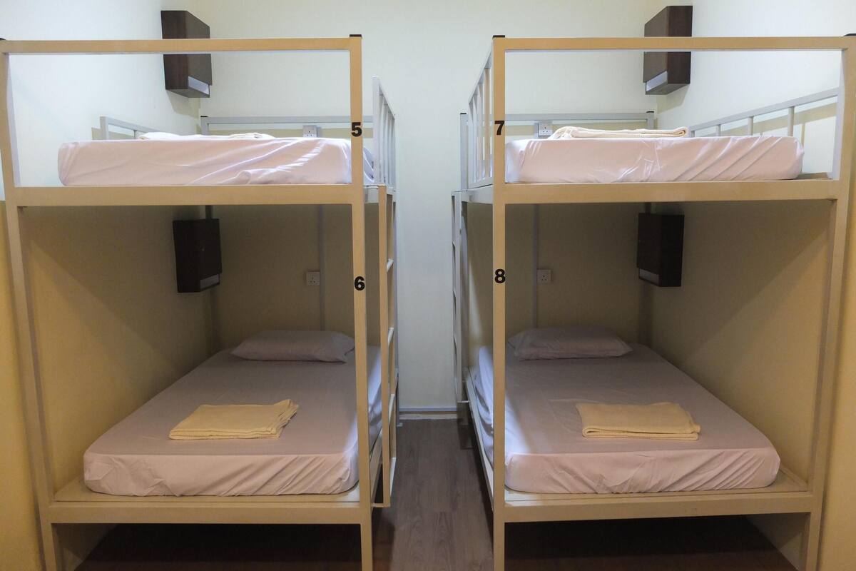 A set of bunk beds in a room with wooden flooring.