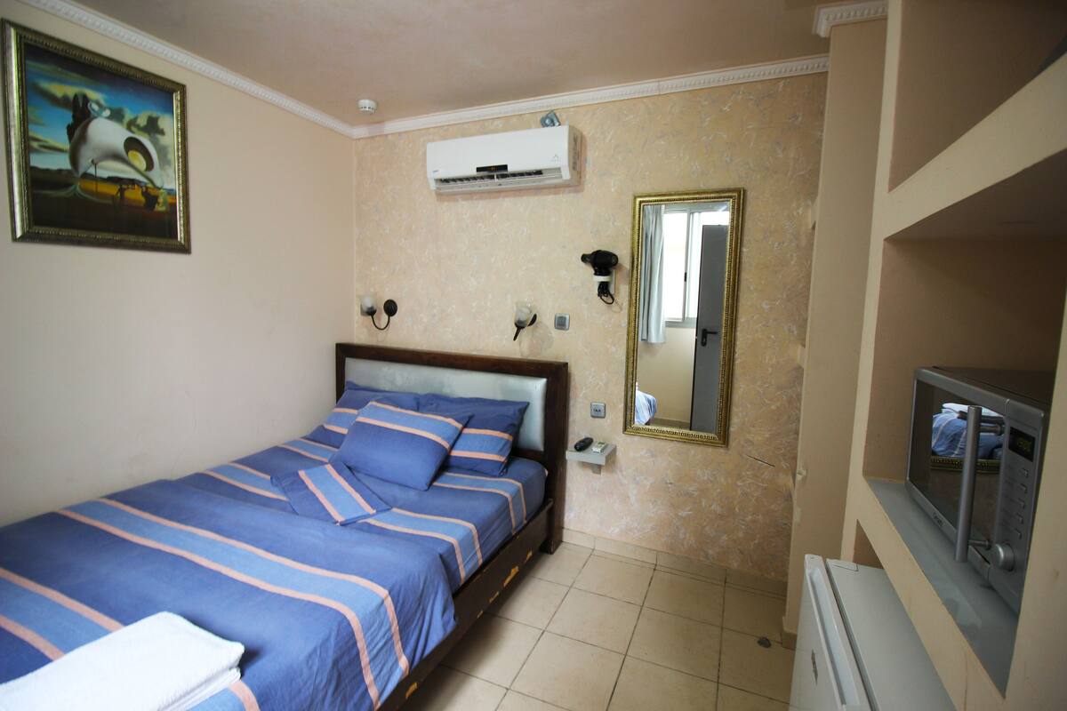 Economy Double Room | Pillow-top beds, minibar, individually decorated, individually furnished