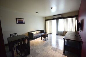 Deluxe 1 Bedroom Apartment | Living area | 42-inch LED TV with digital channels, TV