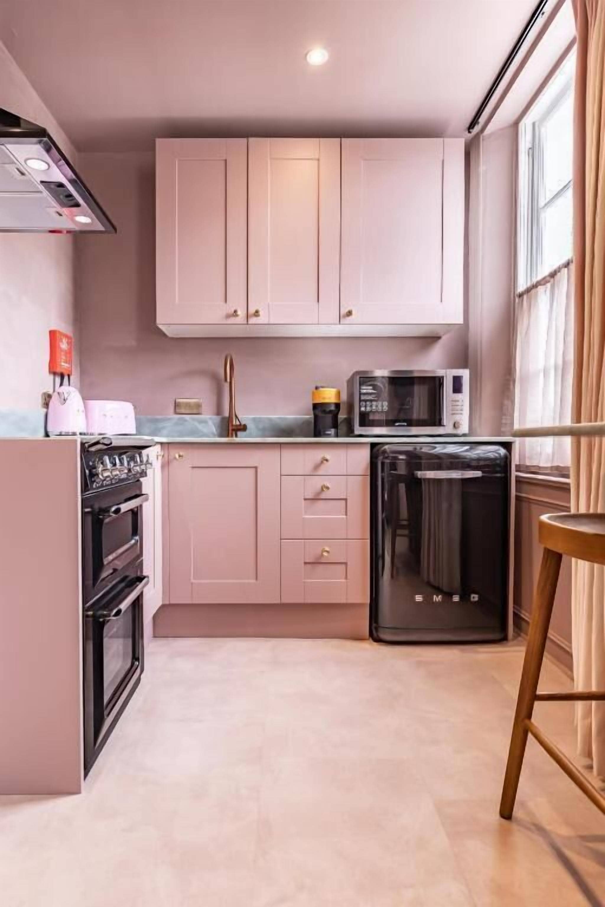 A compact kitchen with a built-in oven, a microwave, and a dishwasher.