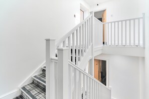 A multi-level staircase with white railings and a checkered carpet. - Best Western Greater London Hotel (Ilford)