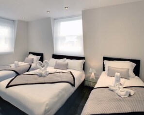 Family Room | Pillow-top beds, in-room safe, desk, laptop workspace