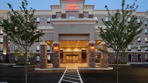 A Hampton Inn & Suites hotel entrance with a brick facade, large windows, and a well-lit entrance. - Hampton Inn & Suites Roanoke Airport (Roanoke)