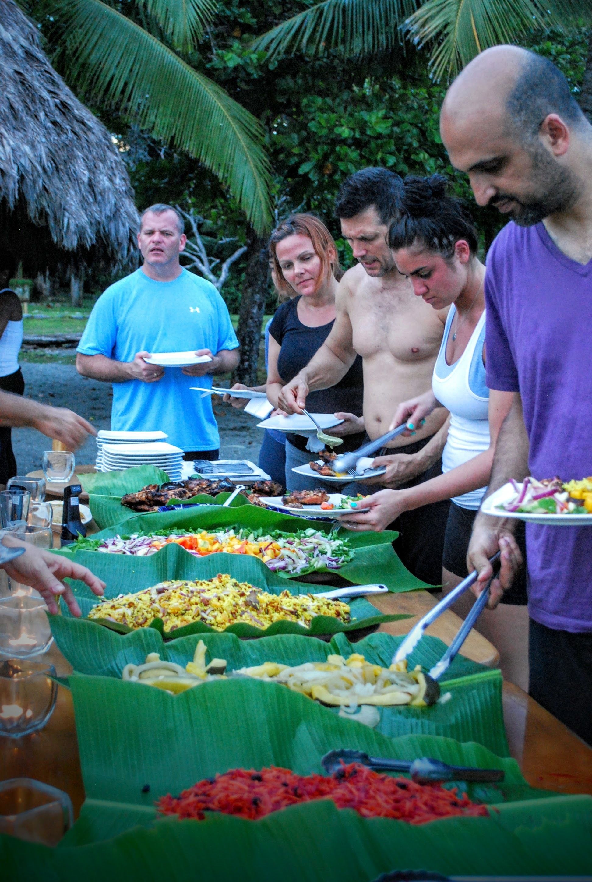 A buffet table with various dishes and utensils.