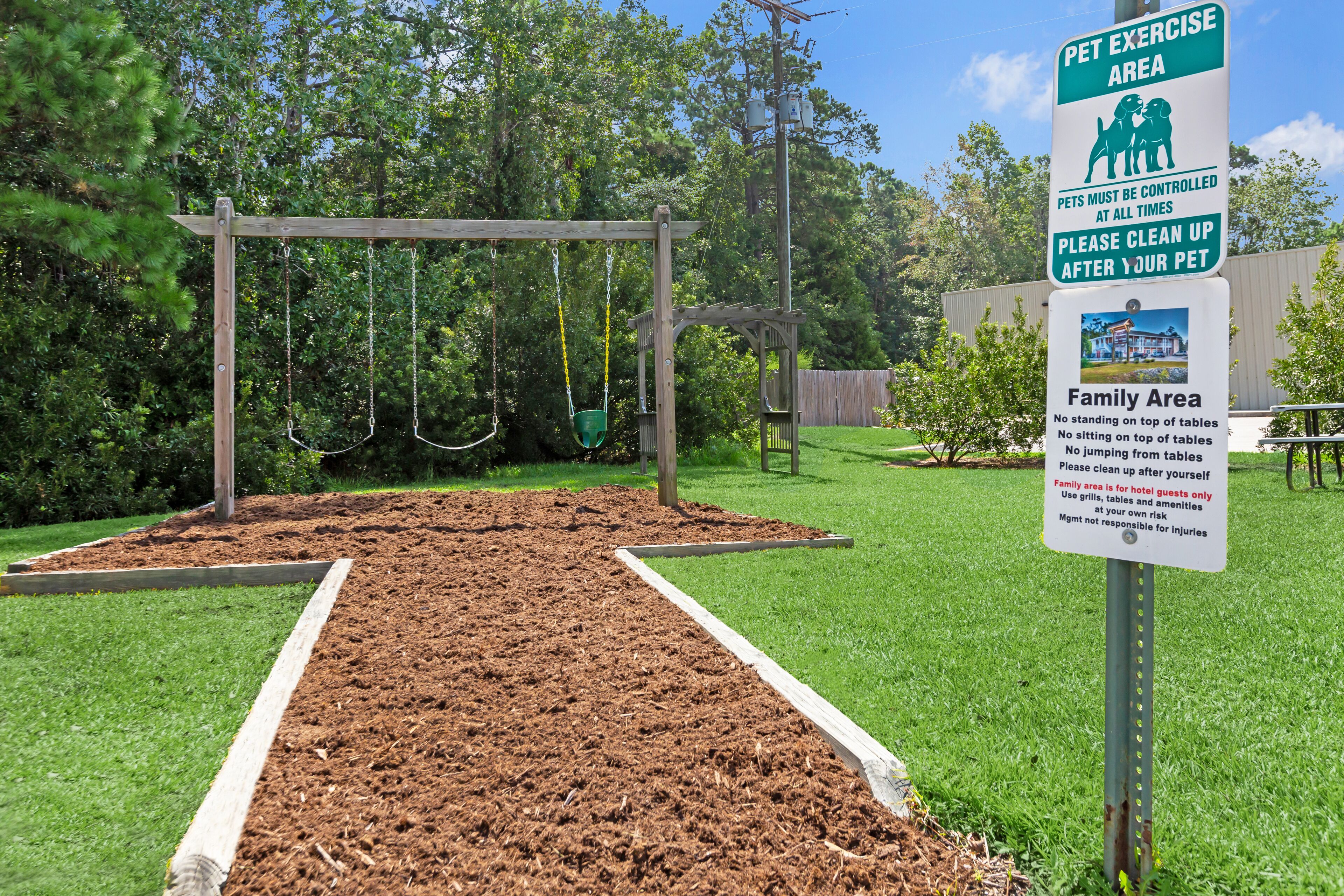 A pet exercise area with swings and a fenced play area.