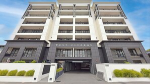 A multi-story hotel with a modern facade, balconies, and a sign reading "WEST FITZROY". - West Fitzroy Apartments (Christchurch)